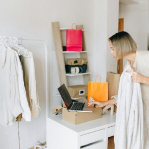 Woman in White Dress Standing in Front of White Wooden Desk